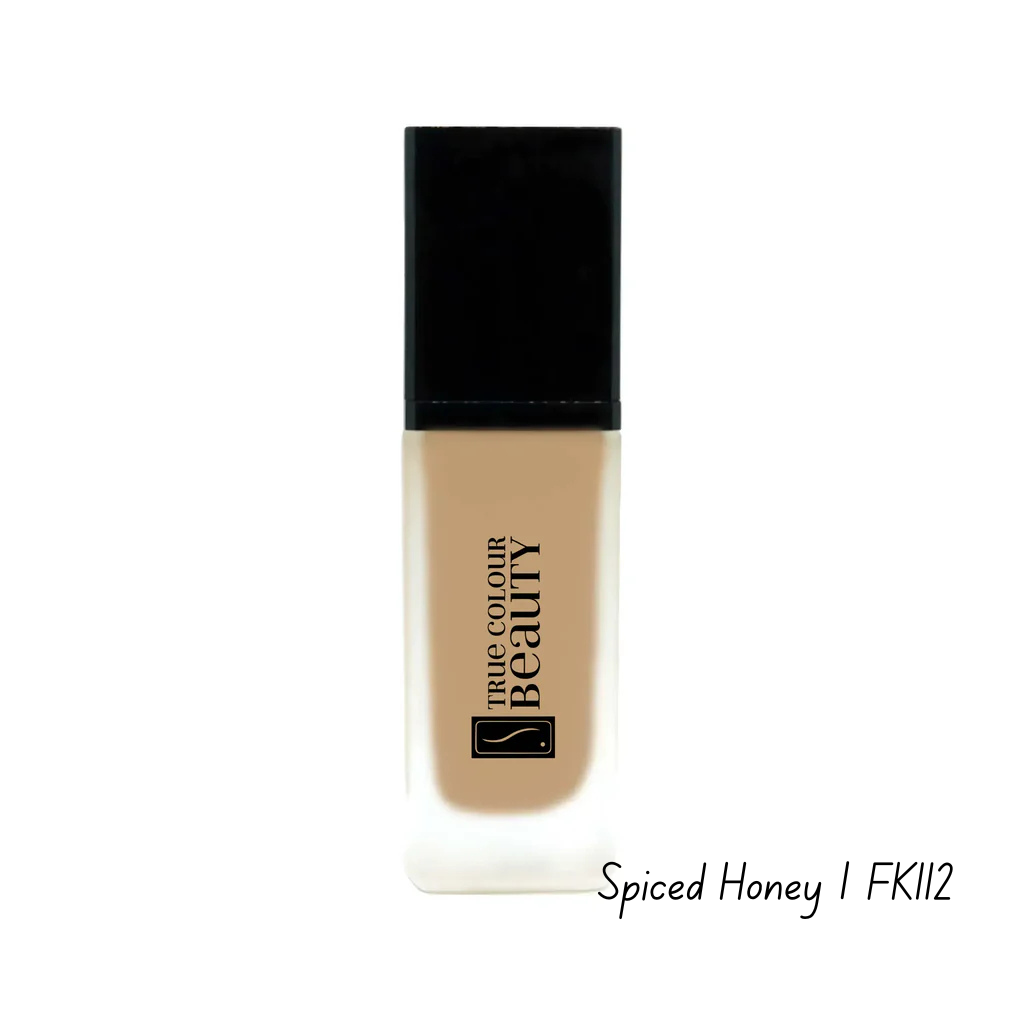 Foundation bottle with black cap and beige body on a white background