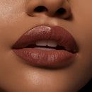 Close-up of a person's lips wearing a brown lipstick.