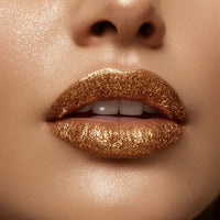 Close-up of lips with gold glitter lipstick on a neutral background