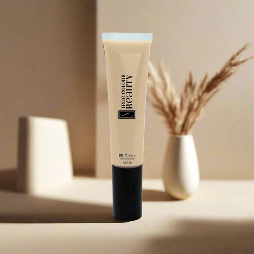 BB Cream - Wheat tube with black cap on white surface, paired with a white vase containing dried plants, reflecting True Colour Beauty's eco-conscious skincare ethos.