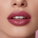 Close-up of a woman's lips with pink lipstick on a neutral background