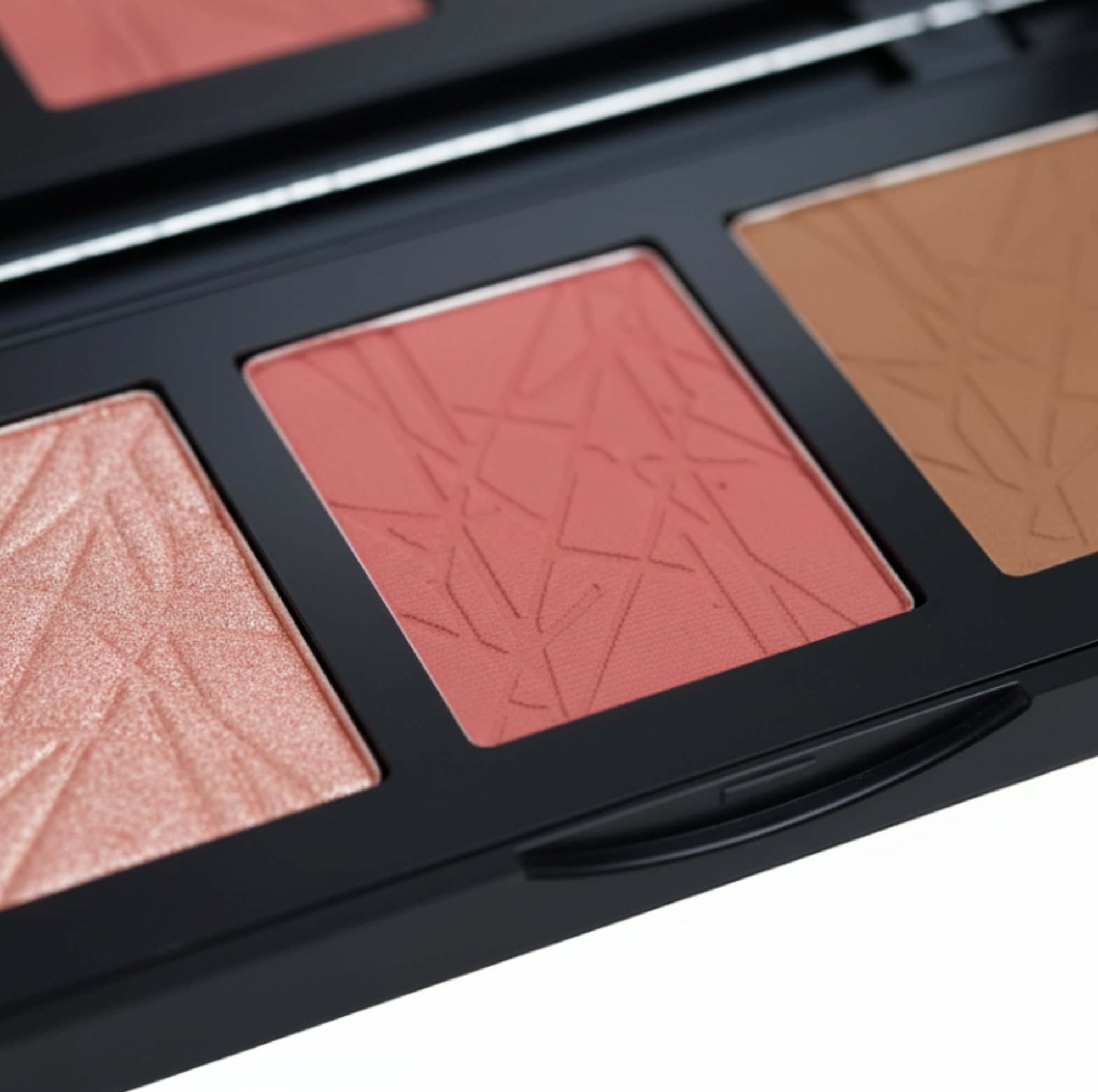 Makeup palette with three shades of blush and bronze on a white background