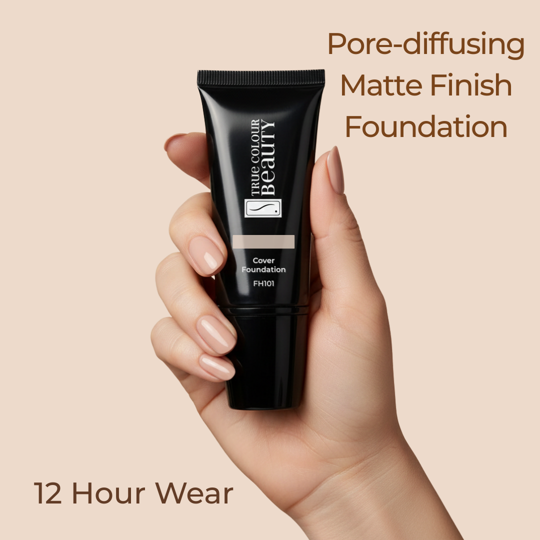 Hand holding a black foundation tube with text about pore-diffusing matte finish foundation on a beige background
