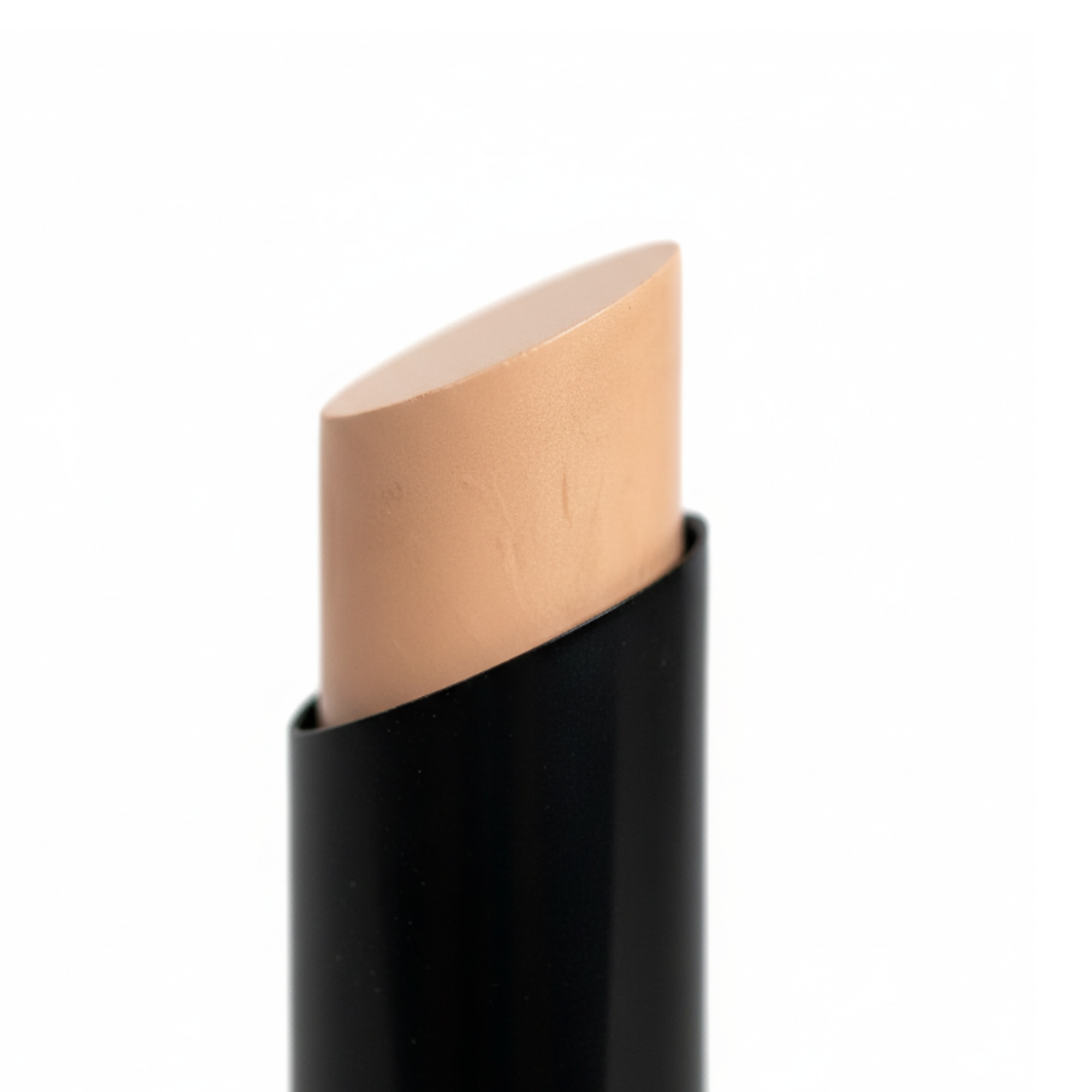 Makeup stick with beige cap on a white background