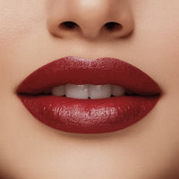 Close-up of a woman's lips with red lipstick on a beige background