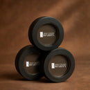 Three black containers with 'True Colour Beauty' logo on a brown background