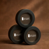 Three black containers with 'True Colour Beauty' logo on a brown background