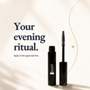 A black mascara tube and wand are shown on a warm cream background 