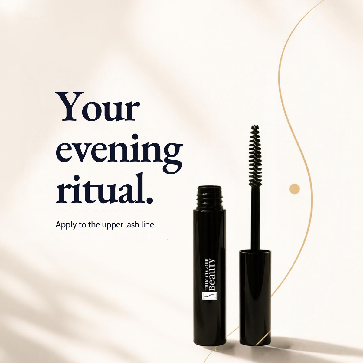 A black mascara tube and wand are shown on a warm cream background 