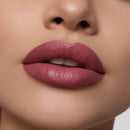 Close-up of a woman's lips with a soft pink lipstick