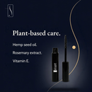 Black mascara tube and wand shown on a dark navy background 