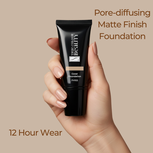 Hand holding a tube of foundation with text about pore-diffusing matte finish and 12-hour wear on a beige background