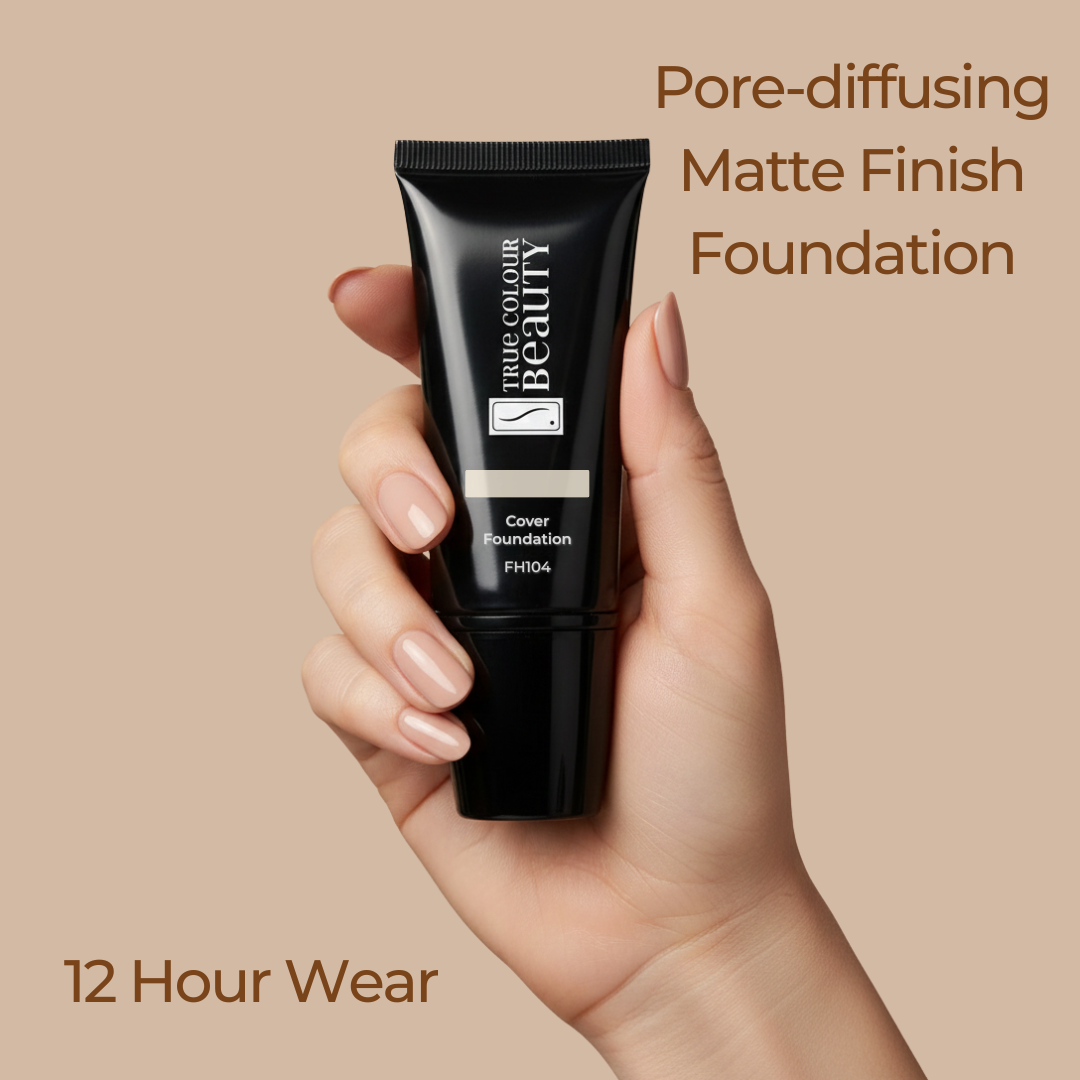 Hand holding a black foundation tube with text about pore-diffusing matte finish foundation on a beige background