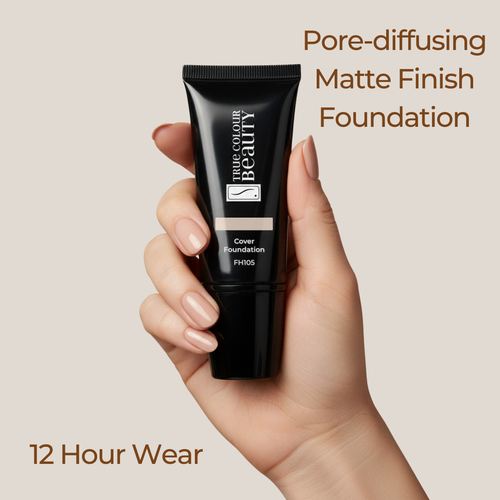 Hand holding a black foundation tube with text about pore-diffusing matte finish foundation on a beige background