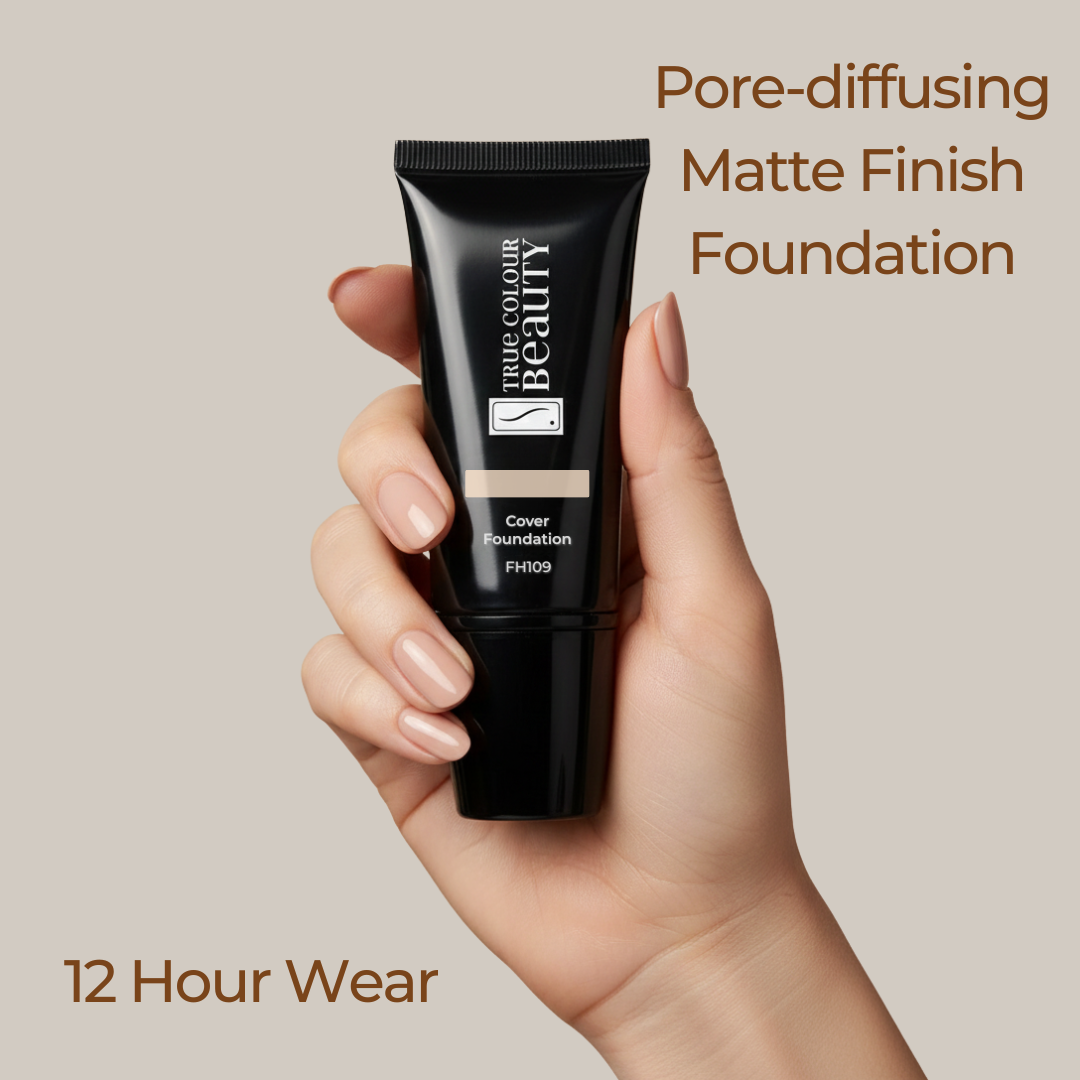 Hand holding a black foundation tube with text about pore-diffusing matte finish foundation on a beige background