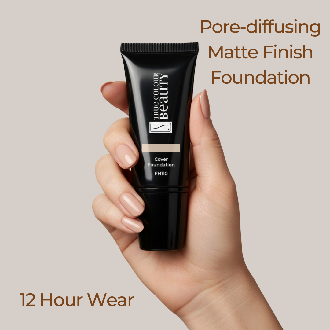 Hand holding a black foundation tube with text about pore-diffusing matte finish foundation on a beige background
