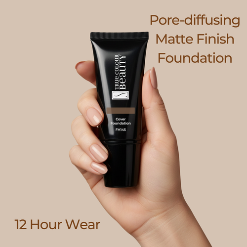 Hand holding a black foundation tube with text about pore-diffusing matte finish foundation on a beige background
