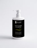 Bottle of True Gloss Shampoo with a black label on a white background