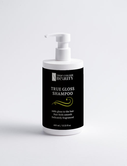 Bottle of True Gloss Shampoo with a black label on a white background