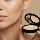 Person holding a compact powder with a neutral background
