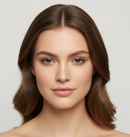 Woman with long, wavy brown hair against a plain background