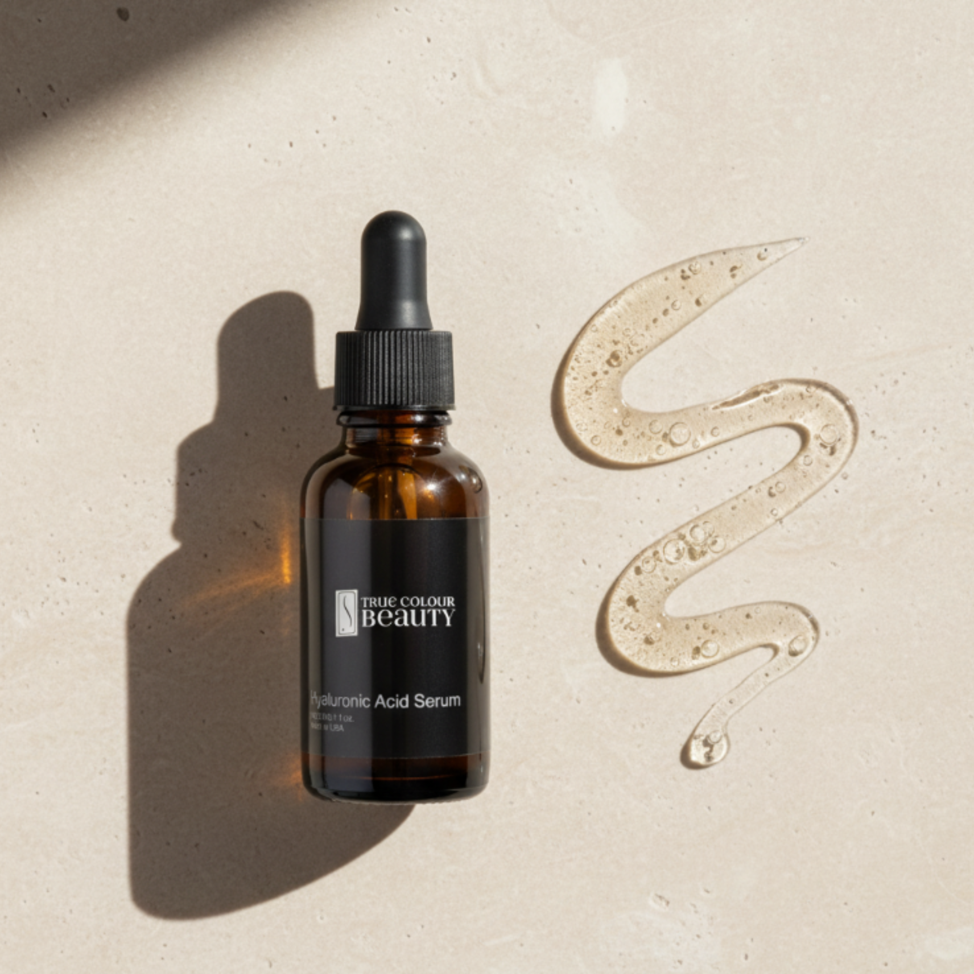Brown serum bottle with dropper on a beige background