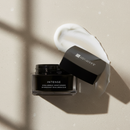 Black skincare jar labeled 'Intense' with a white cream on a beige background