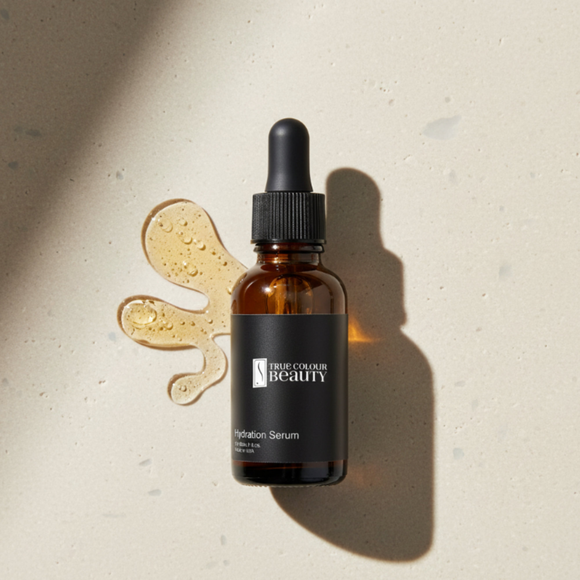 Brown serum bottle with dropper on a beige background