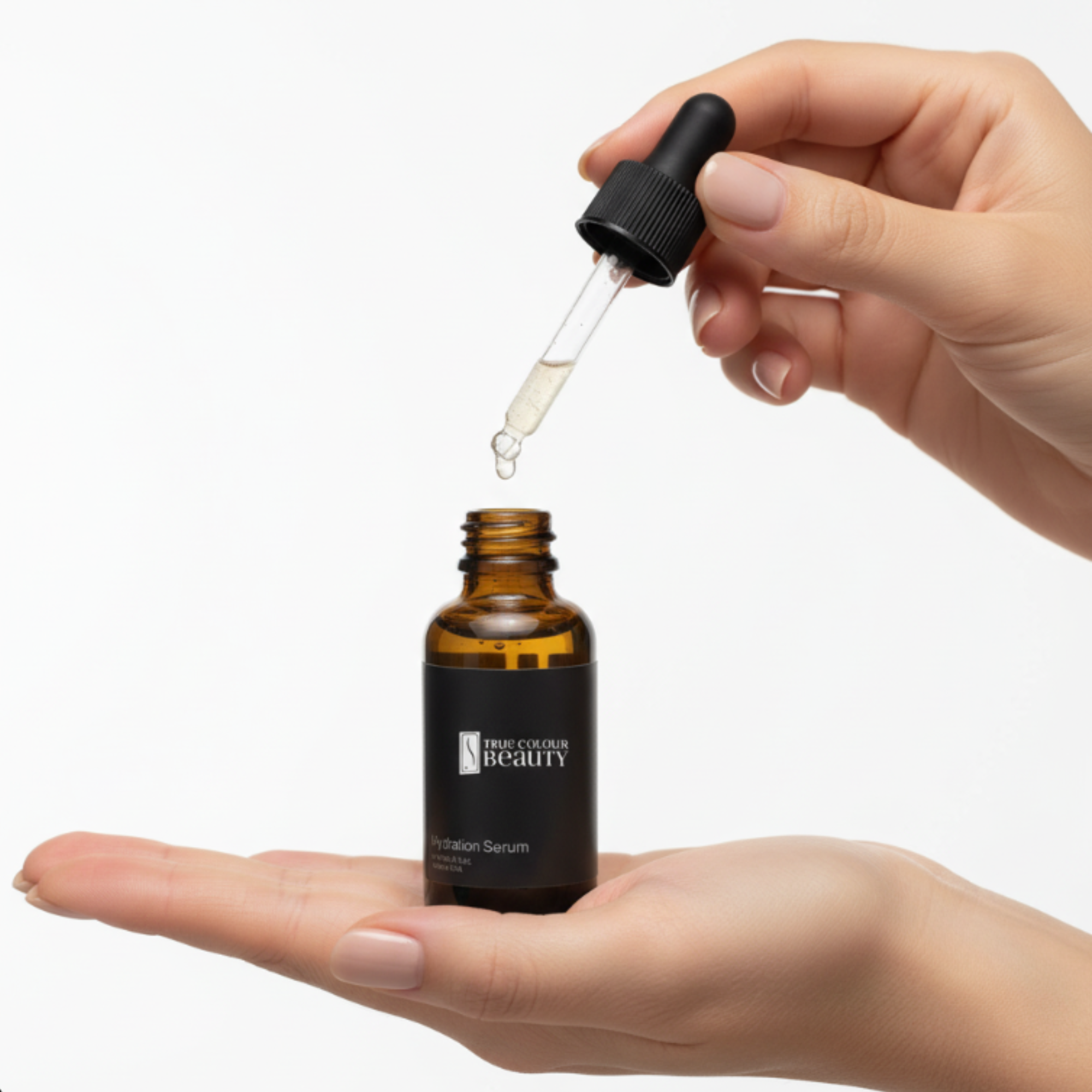 Hand holding a dropper over a bottle labeled 'True Beauty' on a white background