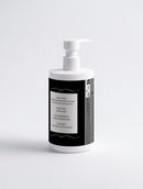 White bottle with a black label on a light gray background