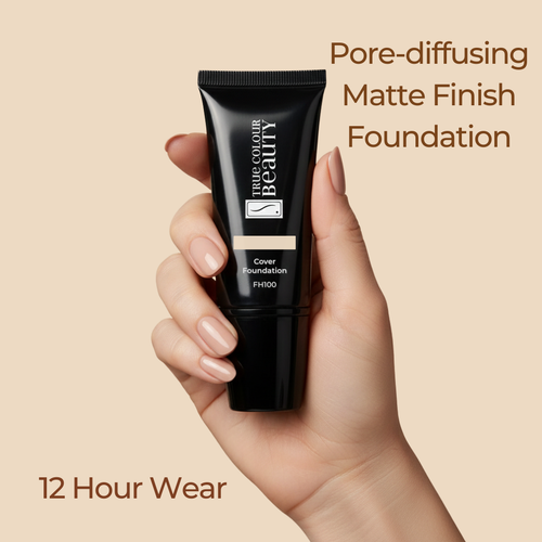 Hand holding a black foundation tube with text about pore-diffusing matte finish foundation on a beige background