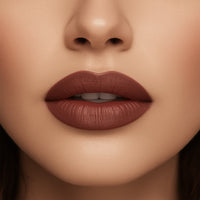 Close-up of a woman's lips with a brown lipstick on a neutral background