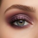 Close-up of a woman's eye with purple eyeshadow