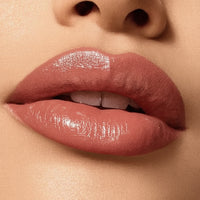Close-up of a person's lips with a glossy lip color