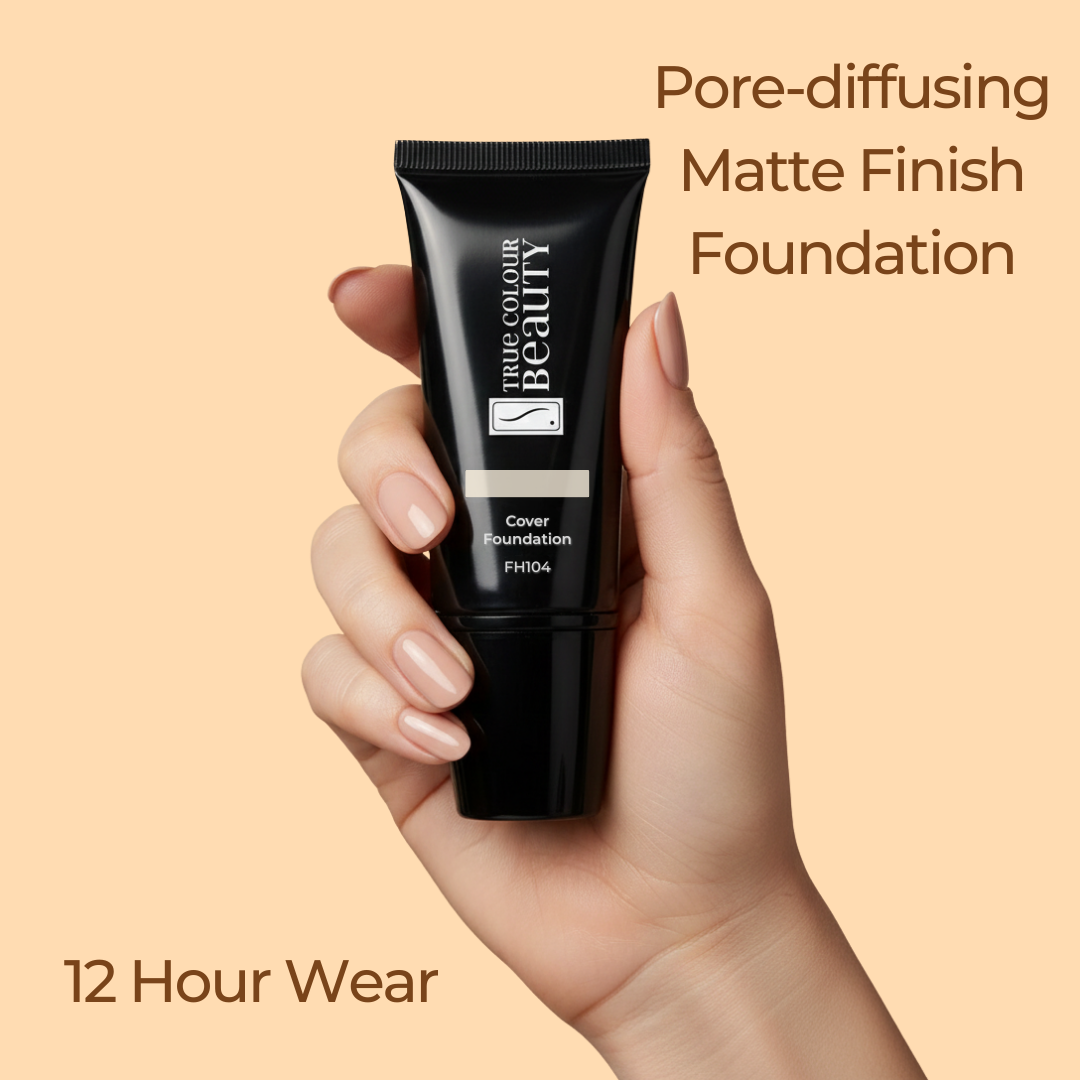 Hand holding a black foundation tube with text about pore-diffusing matte finish foundation on a beige background