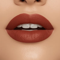 Close-up of a woman's lips with a matte lipstick on a beige background