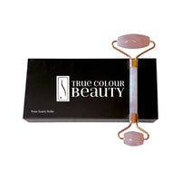 True Radiance Rose Quartz Roller on a black box, designed to detoxify and rejuvenate skin, enhancing skincare product absorption and reducing puffiness with naturally cool stone.