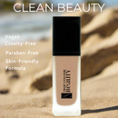 Foundation bottle with 'True Colour Beauty' branding on sand, featuring clean beauty attributes.