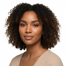 Woman with curly hair wearing a beige top on a white background