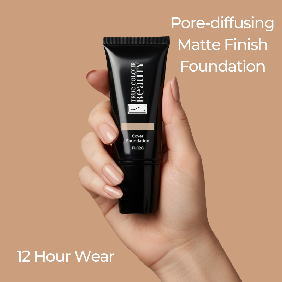 Hand holding a tube of foundation with text about pore-diffusing matte finish and 12-hour wear on a beige background