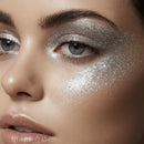Close-up of a person's eye with silver glitter makeup