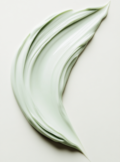 Green cream swatch on a light beige background