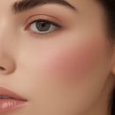 Close-up of a woman's face with pink blush on cheeks