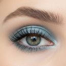 Close-up of a person's eye with blue eyeshadow and defined eyelashes.