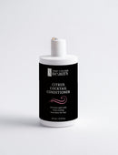 Bottle of Citrus Cocktail Conditioner with black label on a white background