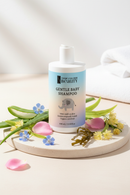 Baby shampoo ingredient shot with aloe, rose, linseed, linden, and seaweed