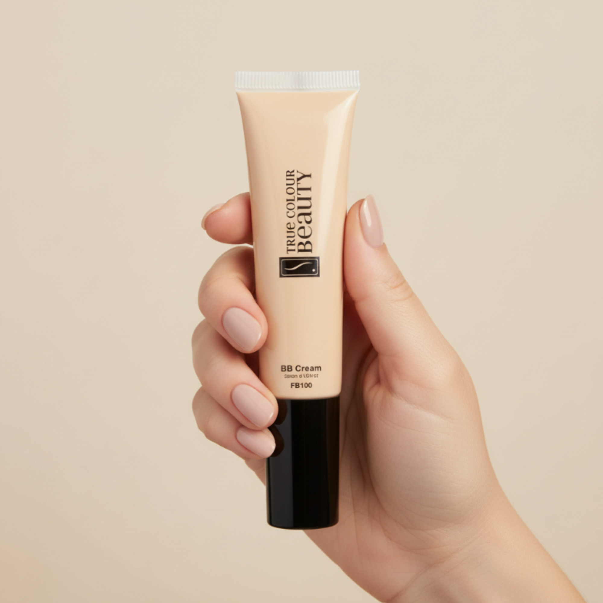 Hand holding a tube of BB cream with a beige background