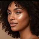 Close-up of a woman with curly hair against a neutral background