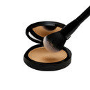 Makeup compact with a brush on a white background