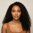 Woman with long, curly black hair wearing a brown tank top against a neutral background